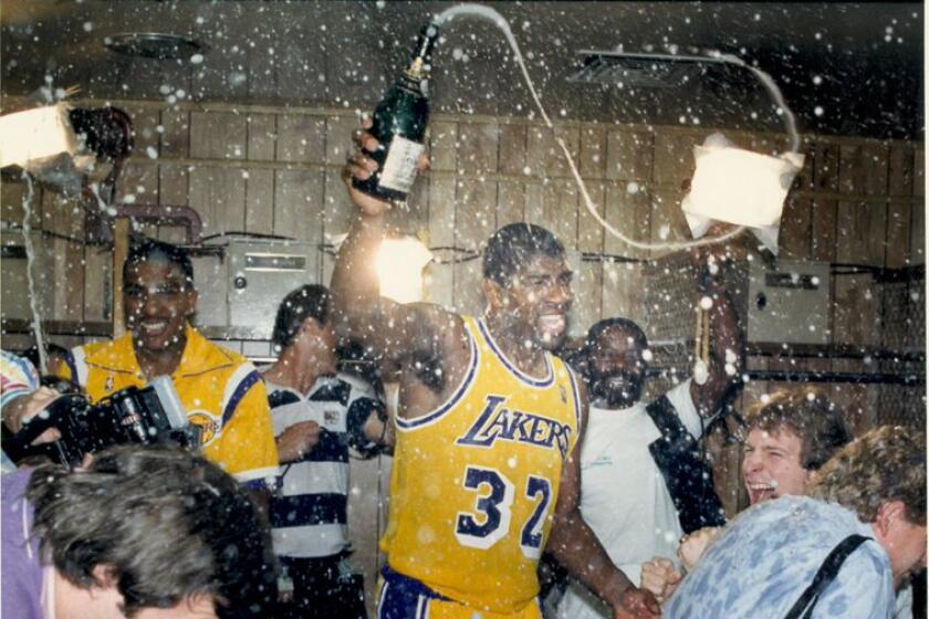Magic Johnson and the Lakers celebrate in the locker room in 1987