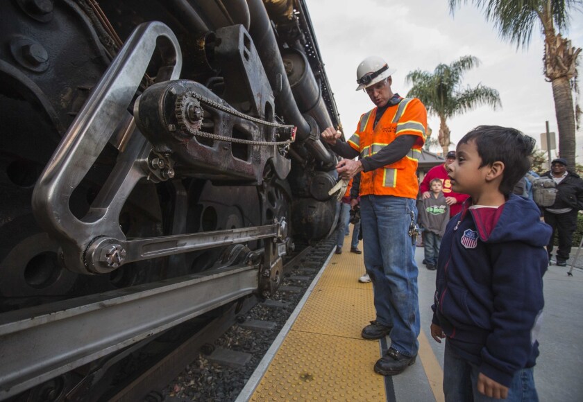 Ed Dickens, senior manager of heritage operations for Union Pacific Railroad, shows Miguel Angel Warner, 4, around engine No. 4014, known as Big Boy, in January in Covina.