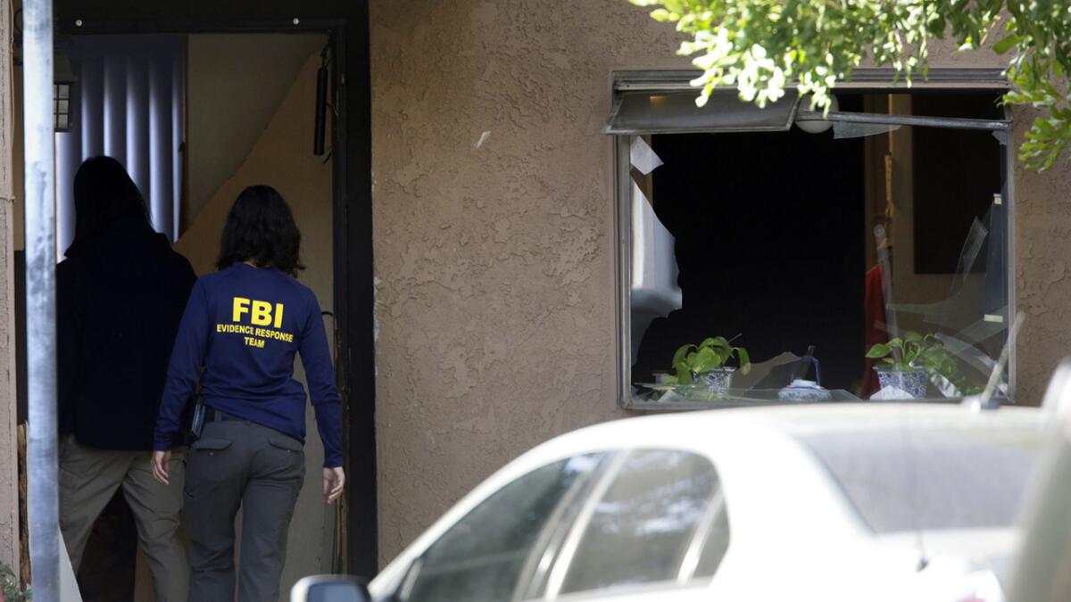 FBI investigators search the suspects' Redlands home on Thursday morning.