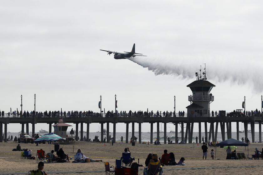Hundreds of people stand along the Huntington Beach pier to watch the opening ceremonies of the Pacific Airshow at the Huntington Beach pier in Huntington Beach on Friday, September 30, 2022. (Photo by James Carbone)