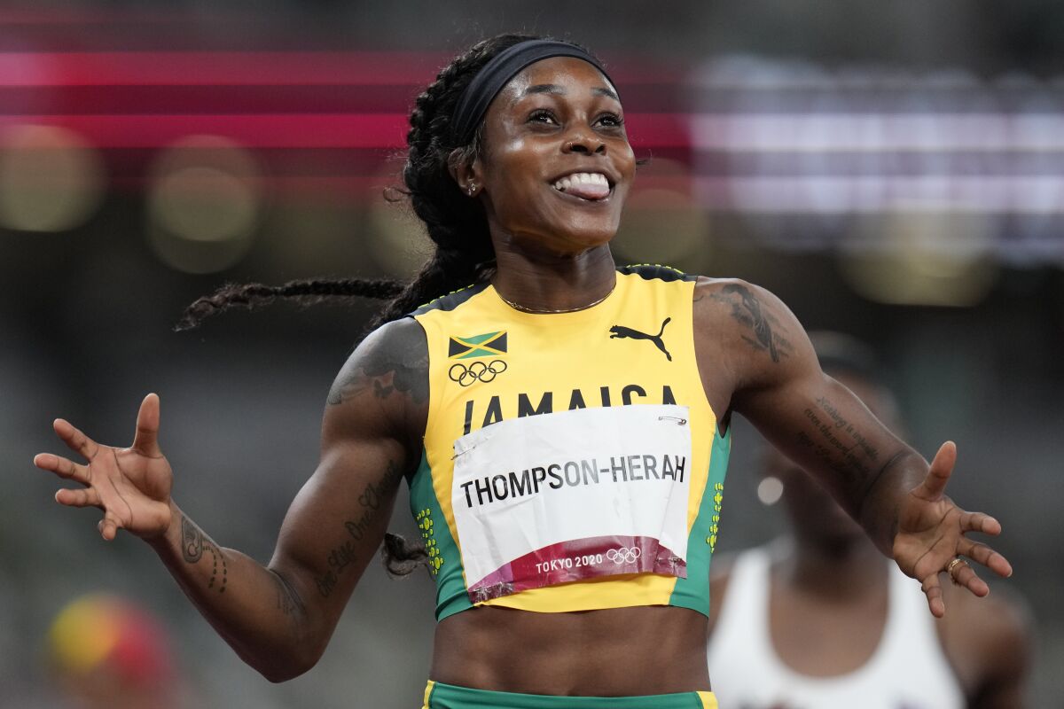 Elaine Thompson-Herah, of Jamaica, reacts after winning the final of the women's 200-meters at the Tokyo Olympics
