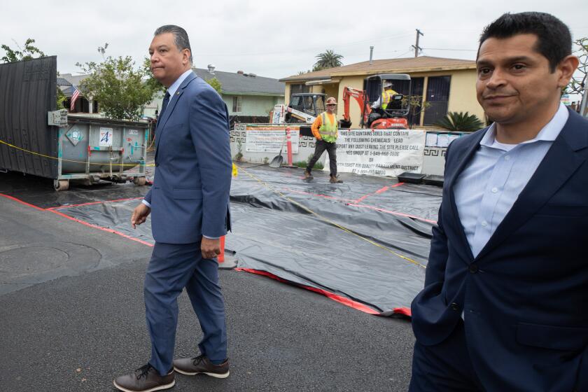 LOS ANGELES, CA - JUNE 09: U.S. Senator Alex Padilla and Assemblymember Miguel Santiago visit a house in the Boyle Heights neighborhood of Los Angeles on Friday, June 9, 2023 that is being cleaned of lead contamination from the shuttered Exide plant. Politicians want the Environmental Protection Agency to designate the cleanup sites a Superfund site to allow access to federal funds. (Myung J. Chun / Los Angeles Times)