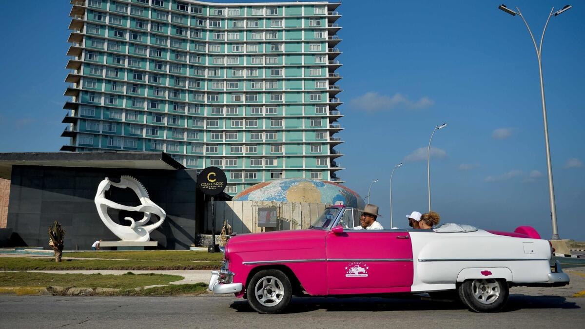 An old American car drives past the Riviera Hotel on May 7, 2019. Cuba welcomed 1.93 million visitors in the first four months of the year, a 7% increase from 2018.