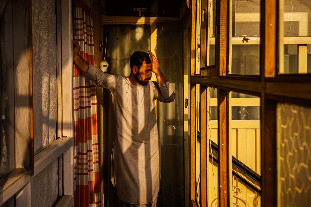 Emal Ahmadi surveys the damage to his family home that was damaged when a U.S. military drone strike 