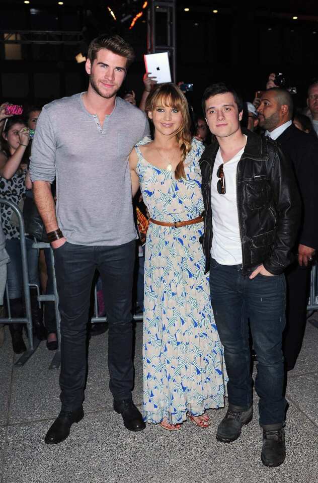 Jennifer Lawrence appears with Liam Hemsworth, left, and Josh Hutcherson at a "Hunger Games" mall event in Century City.