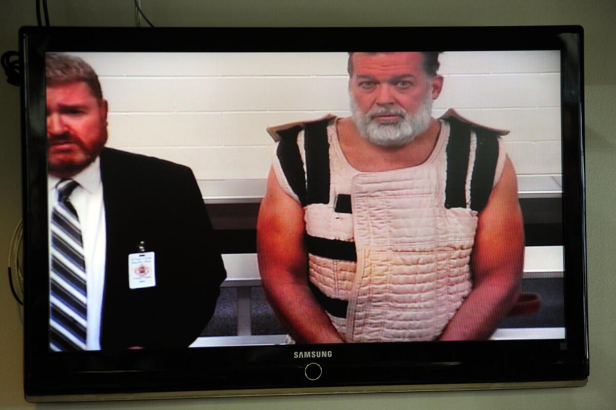 Colorado Springs shooting suspect Robert Dear, with public defender Dan King, appears via video before a judge at the El Paso County Criminal Justice Center on Nov. 30 in Colorado Springs, Colo.