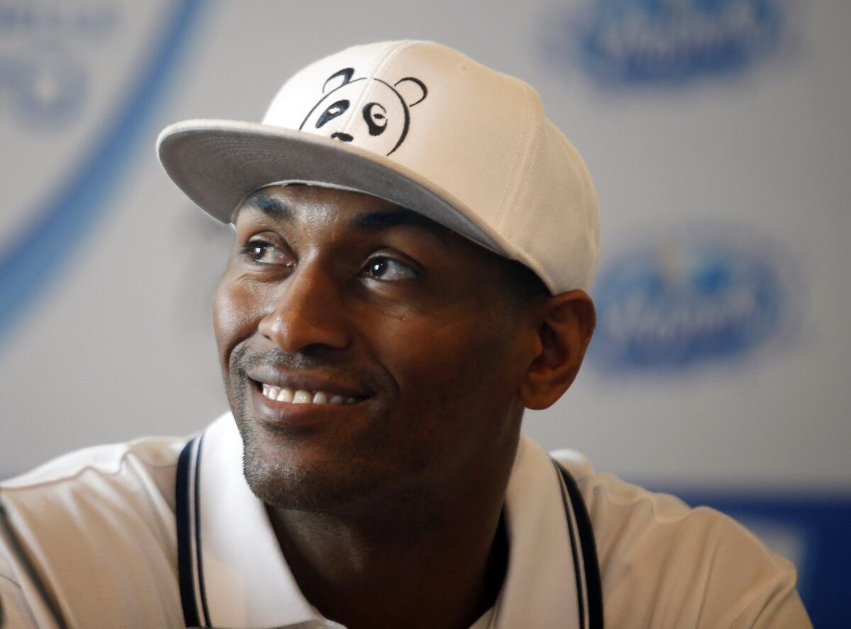 Metta World Peace smiles during a news conference Thursday in Italy after signing with the Italian team Pallacanestro Cantu.