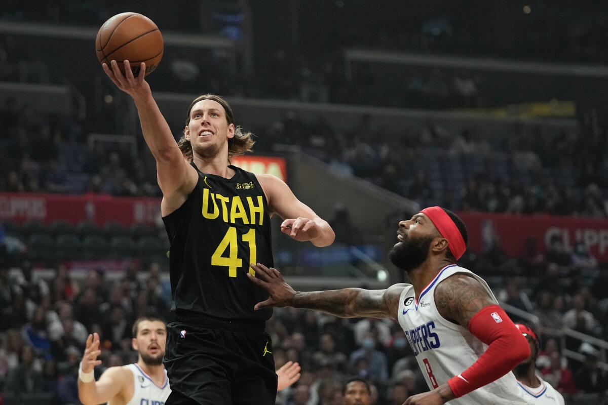 Utah's Kelly Olynyk goes up a shot in front of Clippers forward Marcus Morris Sr. during the Clippers' loss Sunday.