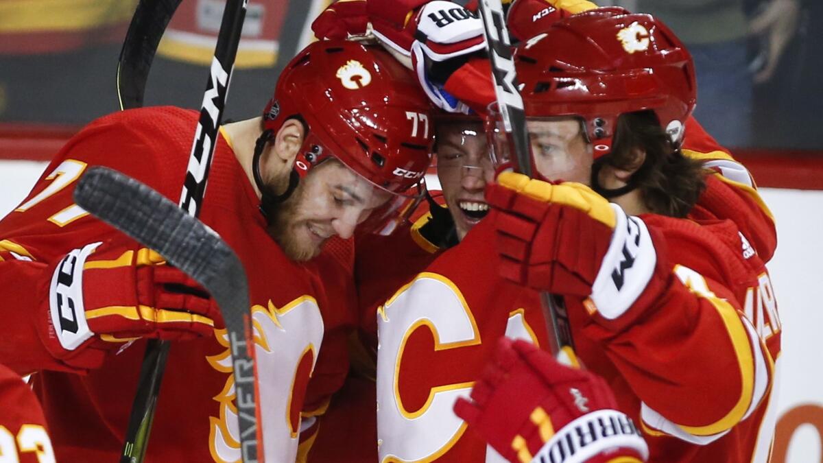 Calgary Flames' Mark Jankowski, left, celebrates his goal against the New York Islanders with teammates during the third period on Wednesday.