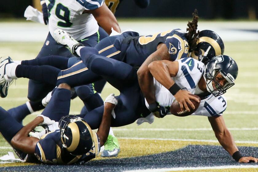 The Rams' Mark Barron, top, sacks Seattle's Russell Wilson on Sept. 13.