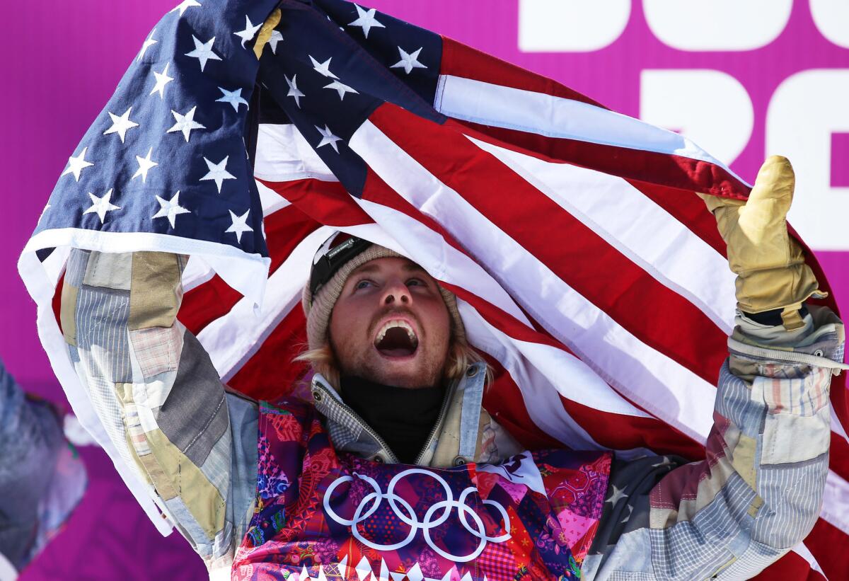 Sage Kotsenburg celebrates his snowboard slopestyle gold medal win. Worried about his parents' safety, he had asked them to stay home. "For his peace of mind, we decided to back off," says his mom, Carol Ann. "It was one of the hardest things I've ever done."