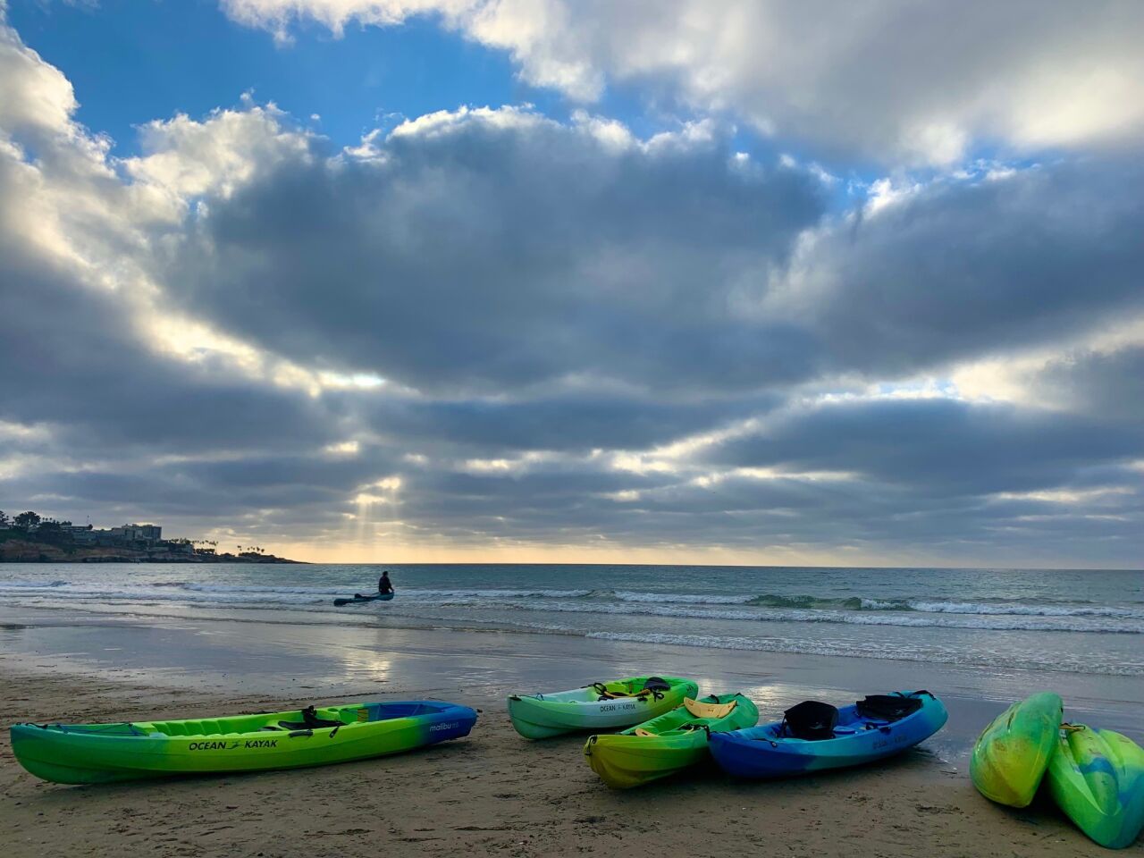 Kayaks sit on the beach upon their return to La Jolla Shores at the end of the day.