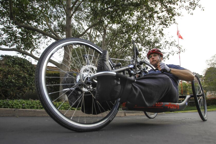 Juan Carlos Vinolo rides his handcycle near his home in La Jolla.
