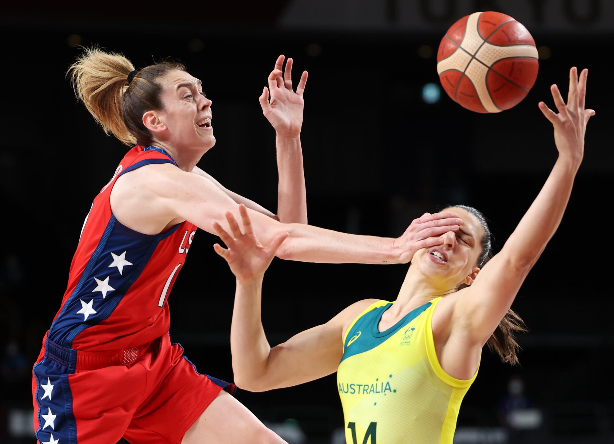 Australia's Marianna Tolo is hit in the face by the USA's Breanna Stewart as they chase a loose ball 