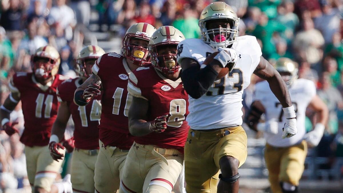 Notre Dame's Josh Adams breaks away from Boston College's Will Harris (8) during a Sept. 16 game.