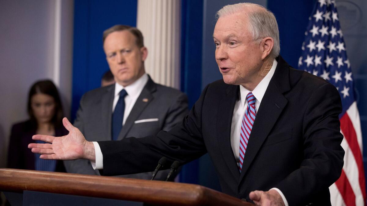 Attorney General Jeff Sessions, right, accompanied by White House press secretary Sean Spicer, talks to the media during the daily press briefing at the White House in Washington, Monday, March 27, 2017. (AP Photo/Andrew Harnik)