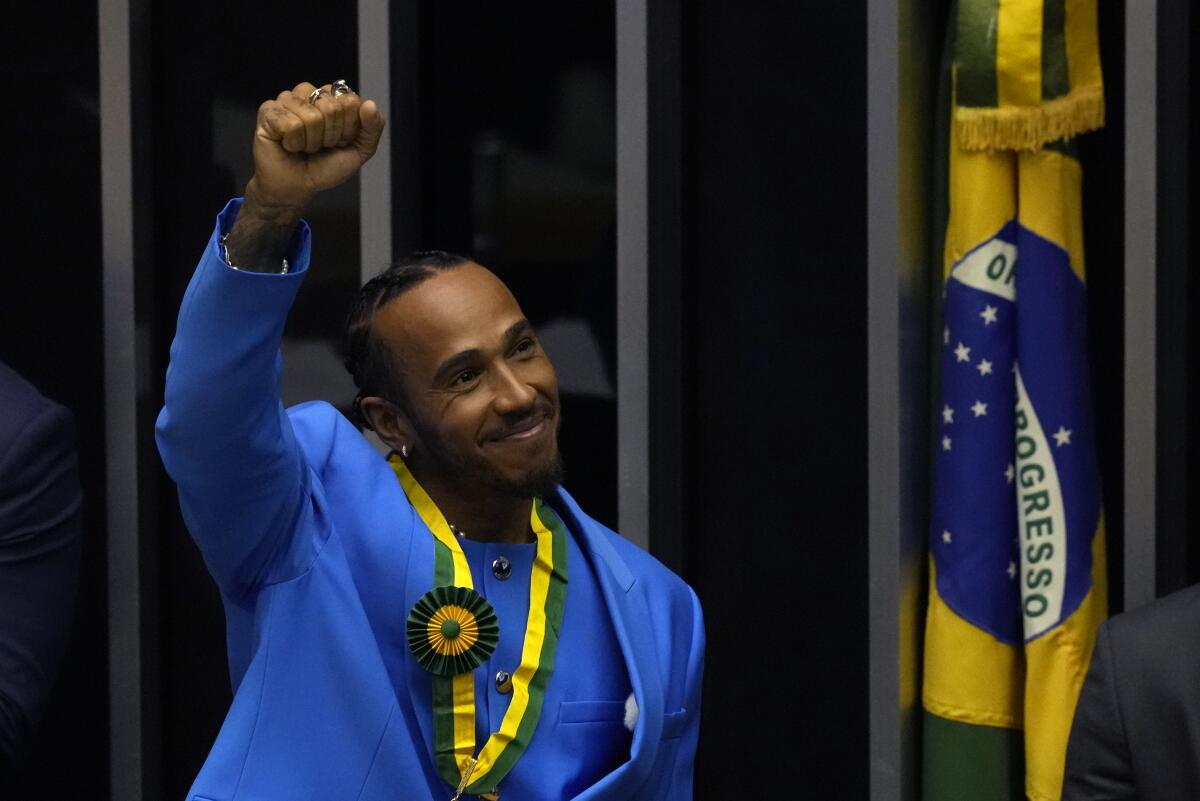 British Mercedes Formula One driver Lewis Hamilton acknowledges the crowd during a ceremony to receive the title of Honorary Citizen of Brazil at the Chamber of Deputies in Brasilia, Brazil, Monday, Nov. 7, 2022. (AP Photo/Eraldo Peres)