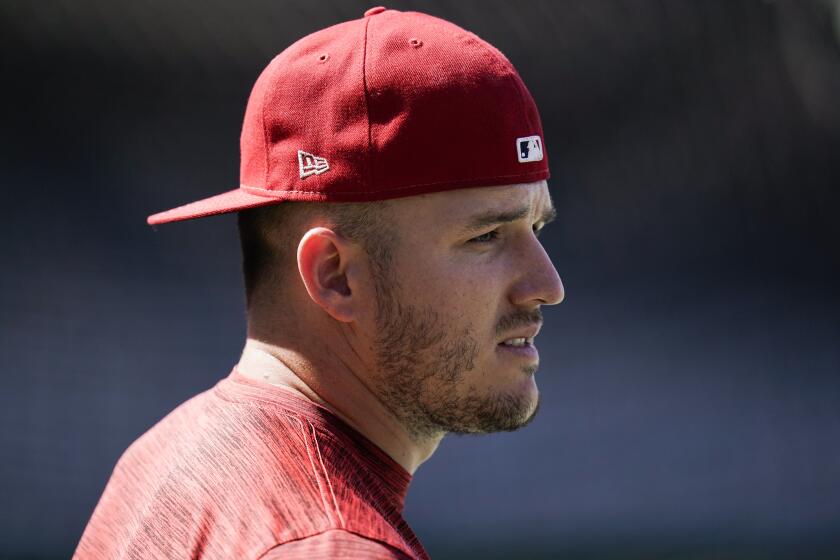 Los Angeles Angels' Mike Trout stands on the field during batting practice.