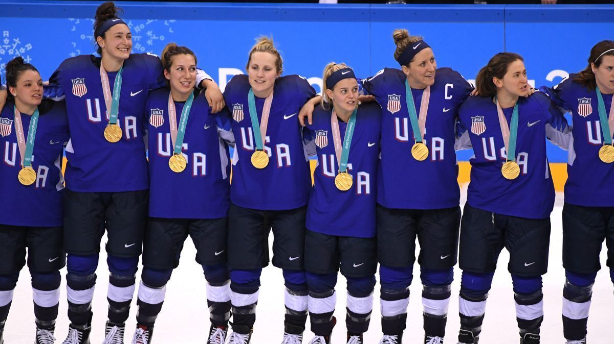 U.S. women's hockey celebrate during the victory ceremony after defeating Canada in a shootout in the Women's Gold Medal Game on Thursday.