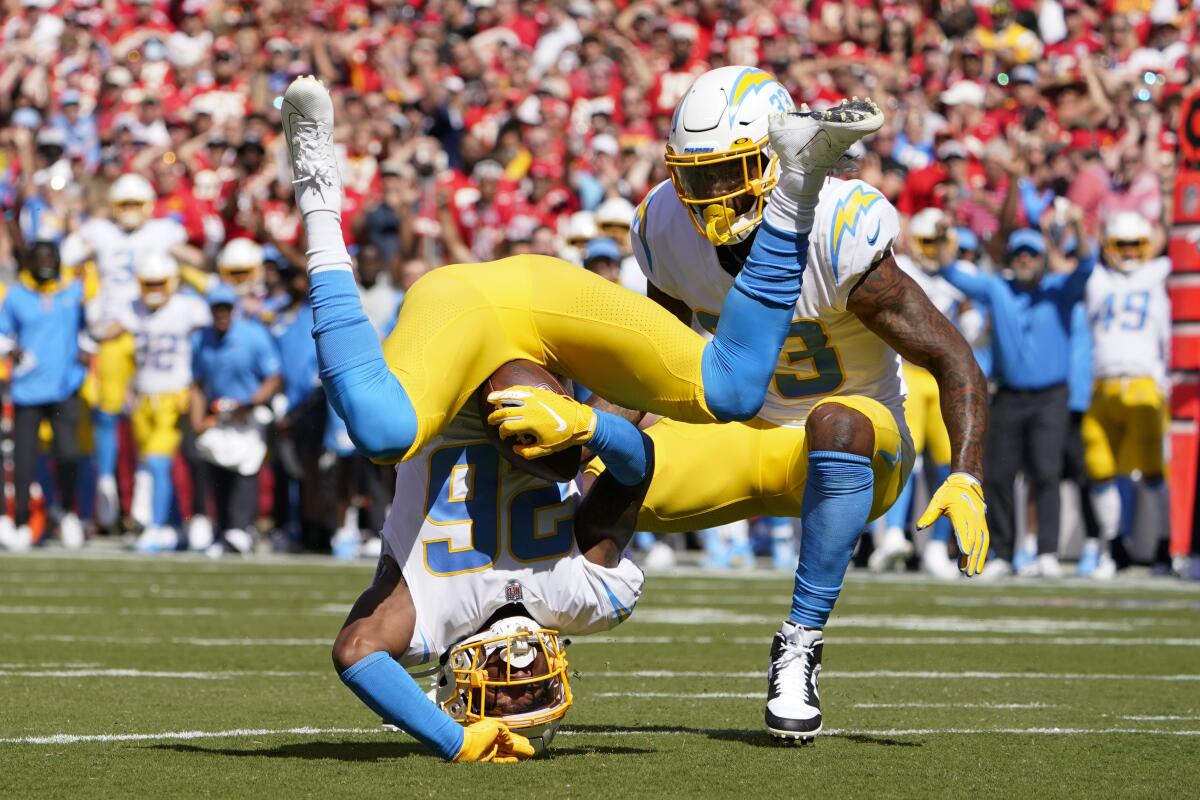 Chargers' Asante Samuel Jr. (26) makes an interception and an awkward landing against the Chiefs.