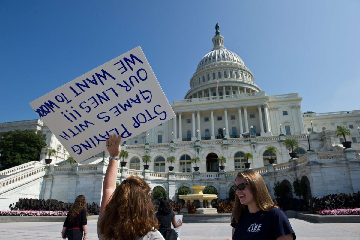 Federal workers demonstrate against the government shutdown in front of the US Capitol in Washington on Friday.