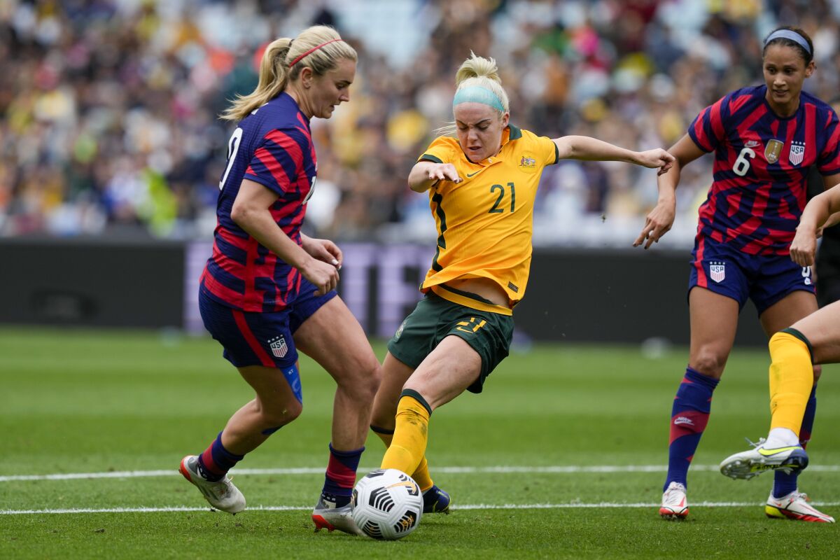 United States' Lindsay Horan, left, and Matilda's Ellie Carpenter compete for the ball during the international soccer match between the United States and Australia at Stadium Australia in Sydney, Saturday, Nov. 27, 2021. (AP Photo/Mark Baker)