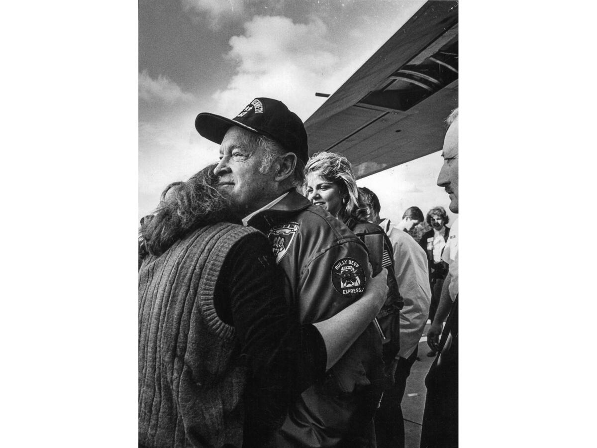 Dec. 27, 1983: Bob Hope gets a hug from an unidentified fan upon his return to Van Nuys Airport after a trip entertaining American troops in Lebanon.