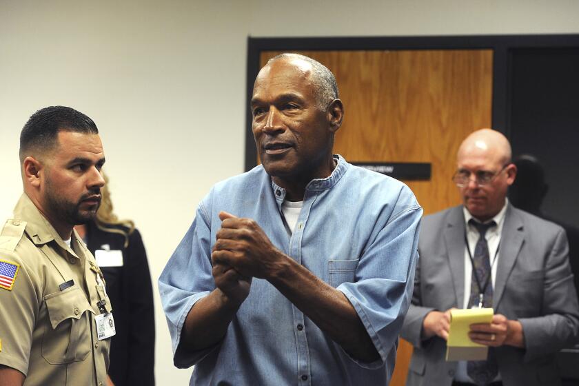 FILE - In this July 20, 2017 file photo, former NFL football star O.J. Simpson reacts after learning he was granted parole at Lovelock Correctional Center in Lovelock, Nev. Simpson, the decorated football superstar and Hollywood actor who was acquitted of charges he killed his former wife and her friend but later found liable in a separate civil trial, has died. He was 76. (Jason Bean/The Reno Gazette-Journal via AP, Pool, File)