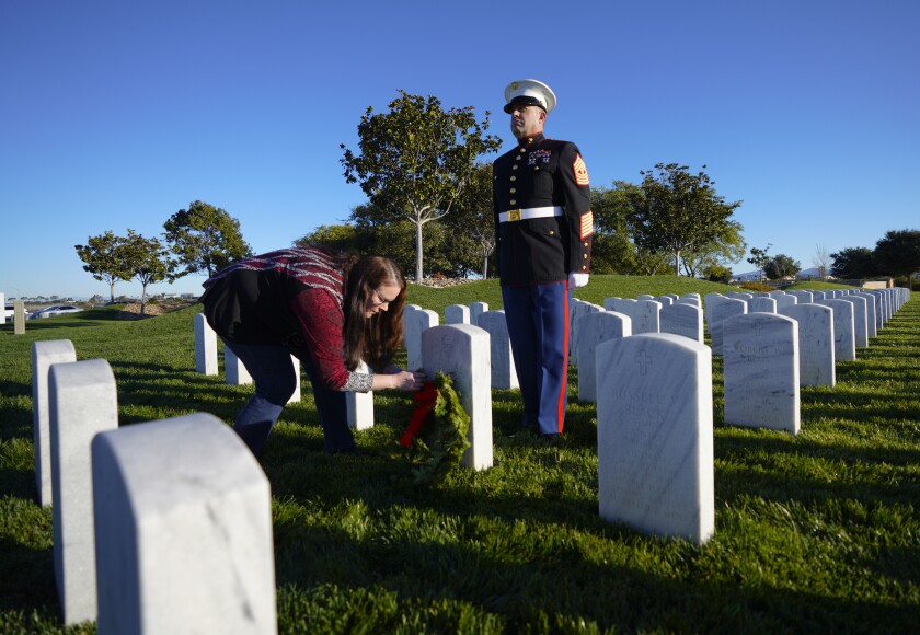 Master Gunnery Sgt. Jason Edwards stood watch over his fellow Marine's headstone as a wreath is placed