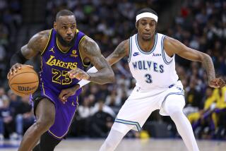 Los Angeles Lakers forward LeBron James, left, works toward the basket as Minnesota Timberwolves.