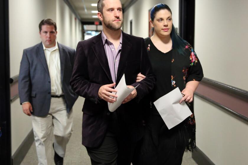 Dustin Diamond enters court in Port Washington, Wis., on Thursday with his girlfriend, Amanda Schutz.