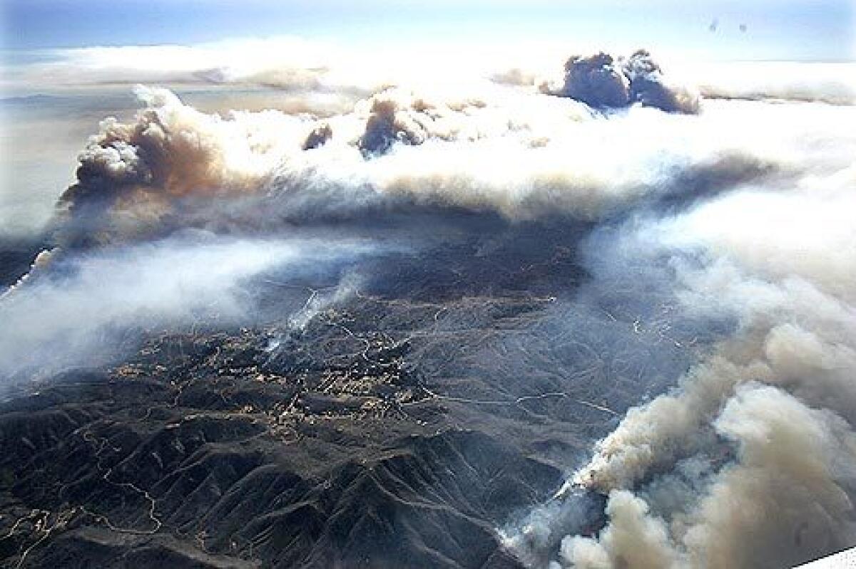 Aerial view: The Esperanza fire sends plumes of smoke high into the air near Banning.