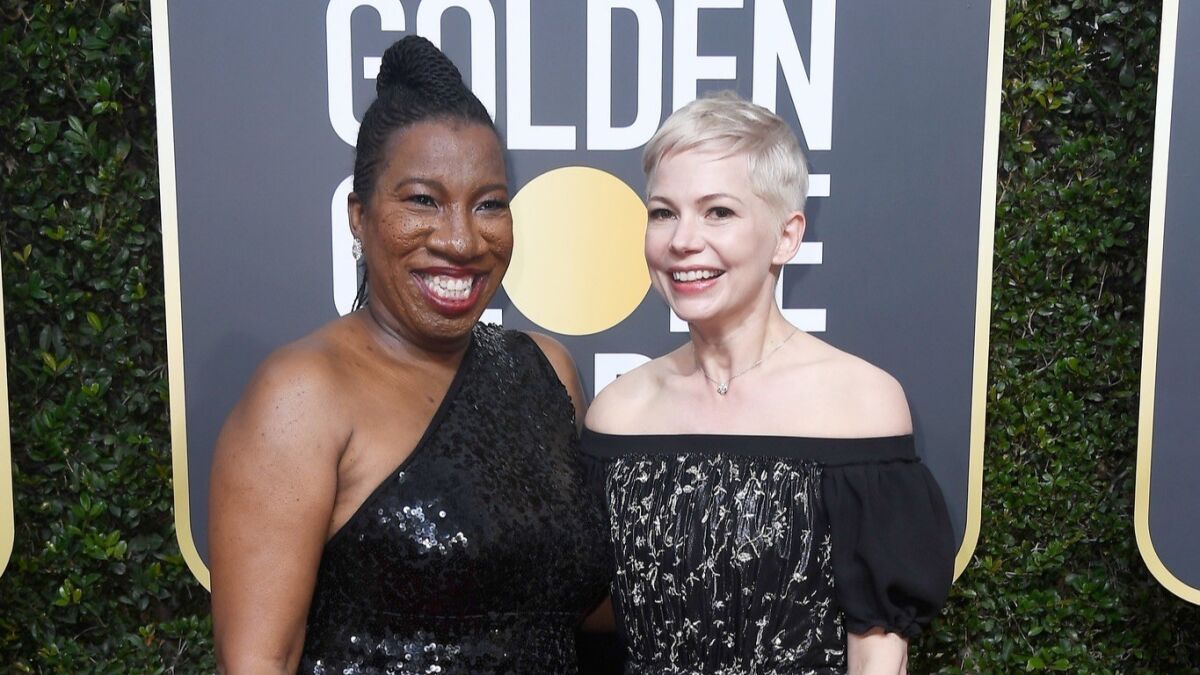 Activist Tarana Burke and Michelle Williams attend the 75th Annual Golden Globe Awards.
