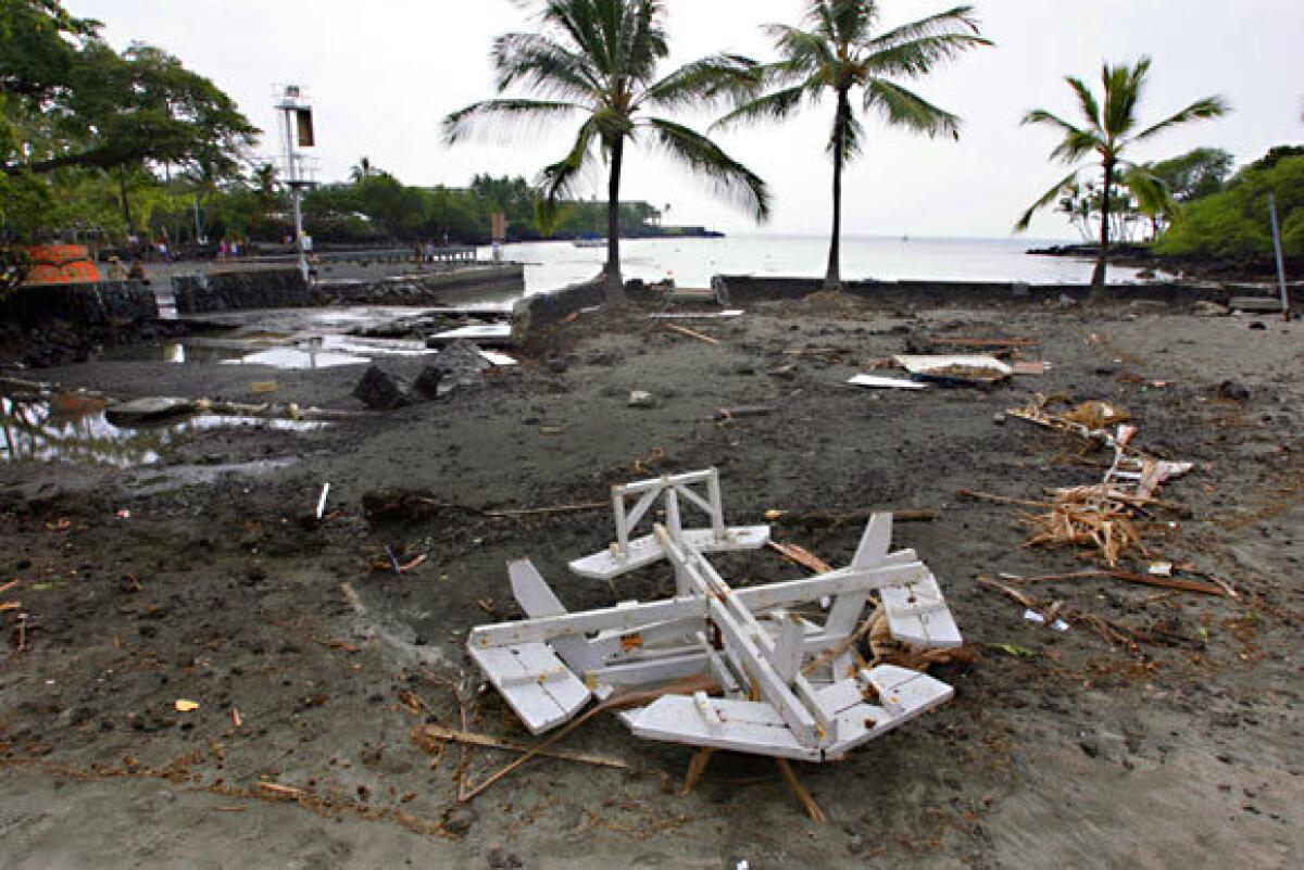 Debris litters a beach after a quake-triggered tsunami struck Keauhou Bay, on the island of Hawaii, on March 11.