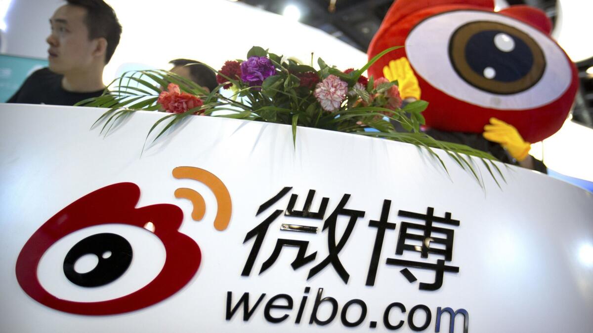 Staffers at a booth for Chinese microblogging website Sina Weibo at an April 2017 internet conference in Beijing.