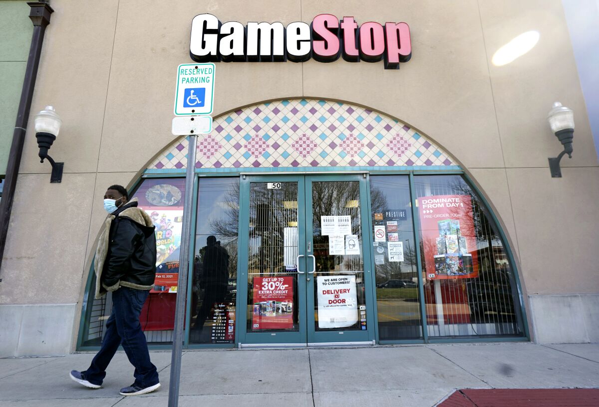 A pedestrian passes a GameStop storefront in Dallas.