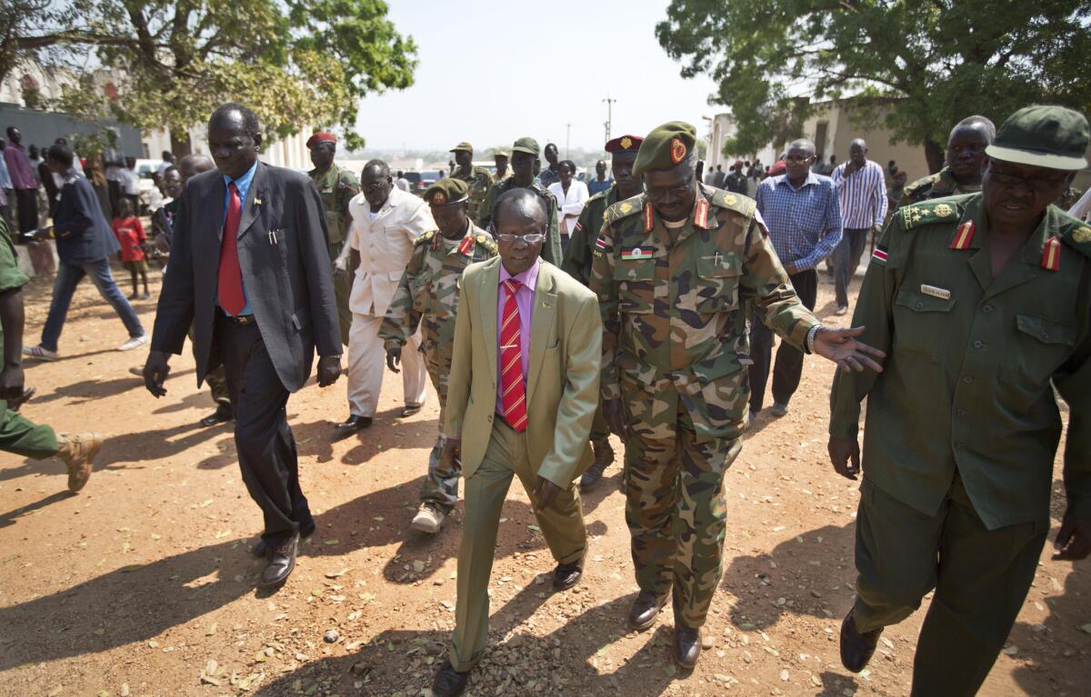 South Sudan's current Vice President James Wani Igga, center left, arrives to visit wounded patients at the Juba Military Hospital in Juba, South Sudan, on Saturday.