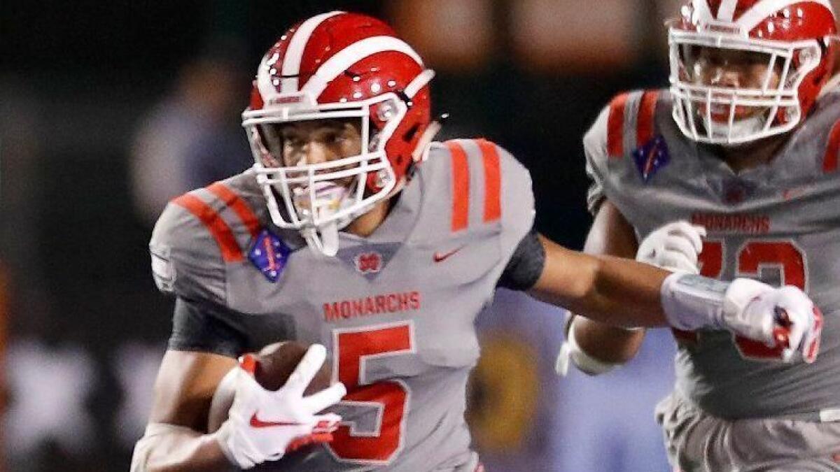 Bru McCoy looks for room to run during a game between Mater Dei and Bosco on Nov. 23, 2018 at Cerritos College.