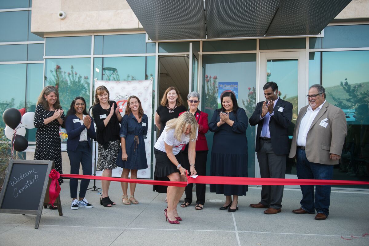 Officials with Poway to Palomar Middle College alongside Poway Unified trustees help celebrate the ribbon cutting on Monday.