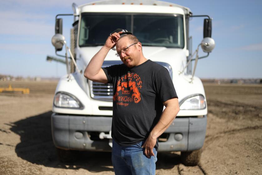 Cancer survivor Charley Butler with a truck he drives at times during the sugar beet harvest in Sidney, Montana, March 30, 2019. Charley Butler, a 36-year-old Montana truck driver who bought a short-term plan in 2016 and then had to fight for more than a year to get tens of thousands of dollars in medical bills paid after he was diagnosed with cancer.âI wonât make that mistake again,â added Butler, who is now suing several of the companies involved in selling and administering his plan.