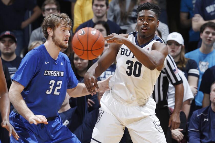 Butler's Kelan Martin (30) passes while defended by Creighton's Toby Hegner (32) in the second half on Tuesday.