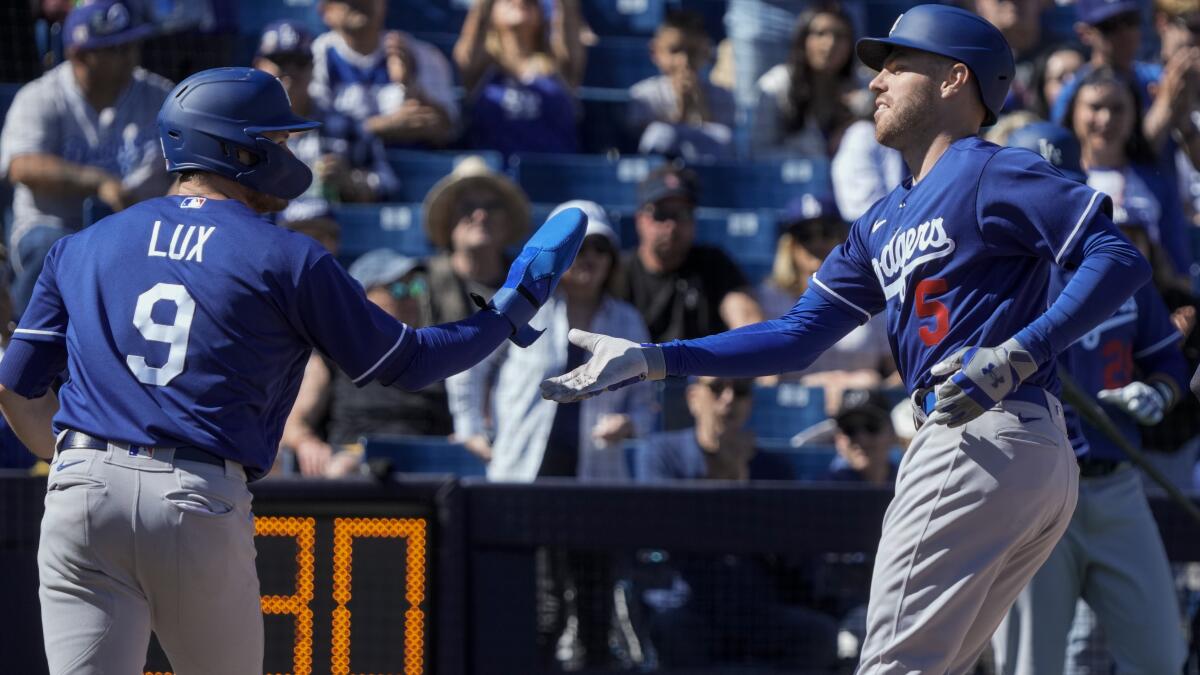 Los Angeles Dodgers catcher Austin Barnes runs with all his catcher's gear  to a practice field during a spring training baseball practice Tuesday,  Feb. 23, 2021, in Phoenix. (AP Photo/Ross D. Franklin