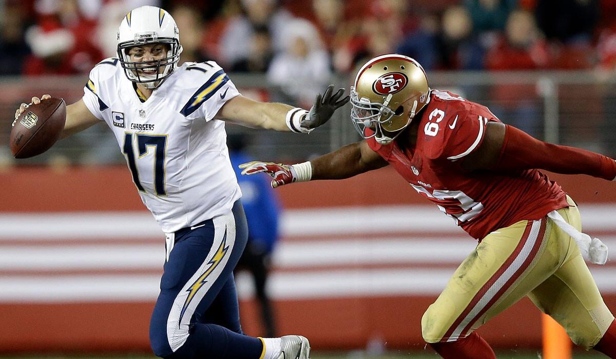 Chargers quarterback Philip Rivers (17) is chased from the pocket by 49ers defensive end Tony Jerod-Eddie in the fourth quarter Saturday night at Levi's Stadium.
