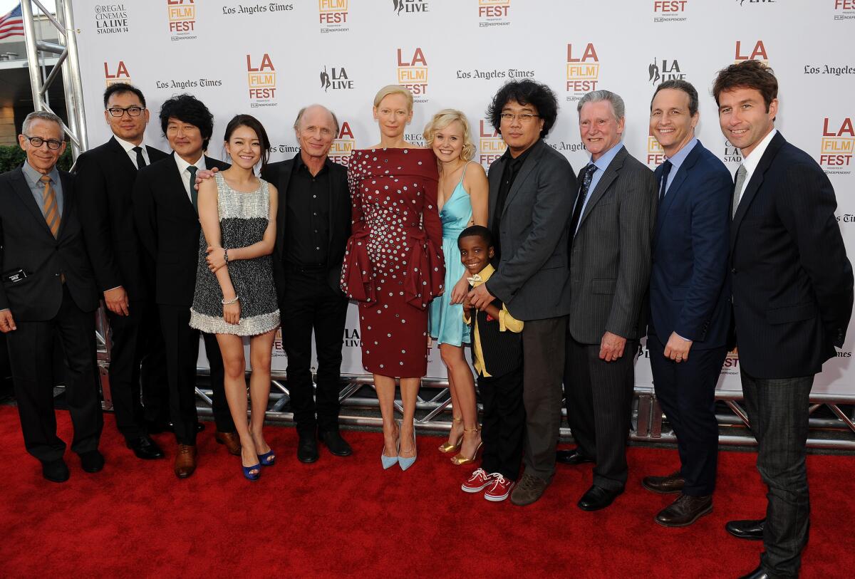 Los Angeles Film Festival artistic director David Ansen, far left, at the opening night premiere of "Snowpiercer" with, from left, an unidentified guest and Song Kang-ho, Ko Ah-sung, Ed Harris, Tilda Swinton, Alison Pill, Marcanthonee Reis, director Joon-ho Bong, writer Kelly Masterson, and RADiUS-TWC Co-Presidents Tom Quinn and Jason Janego outside at L.A. Live.