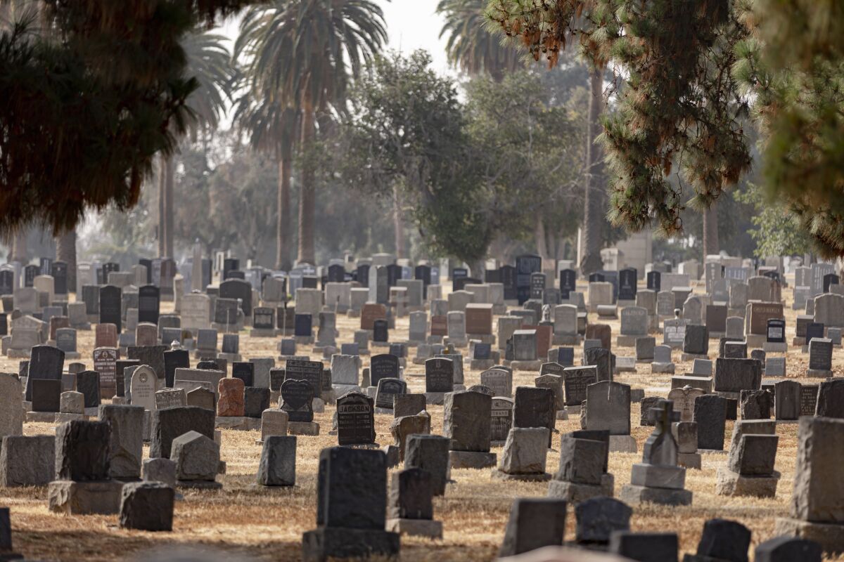 Gravestones stand at Evergreen Cemetery in Boyle Heights 
