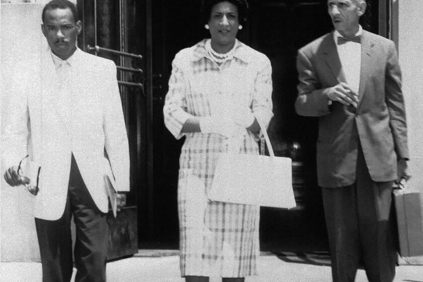 James H. Meredith, 28, left, leaves the courthouse in Meridian, Miss., on June 1, 1961 with his attorneys, Constance Baker Motley, New York, center, and R. Jess Brown, right, Vicksburg lawyer, after conferring with federal district judge Sidney Mize about his suit to enter the University of Mississippi. (AP Photo)