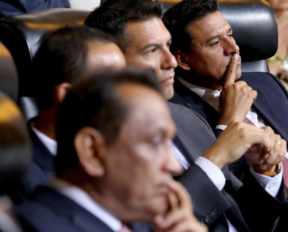 Los Angeles City Councilman Jose Huizar, right, seen during a 2013 council meeting. This month, Huizar secured an override vote to permit a pedestrian bridge connecting two parts of a downtown apartment development.
