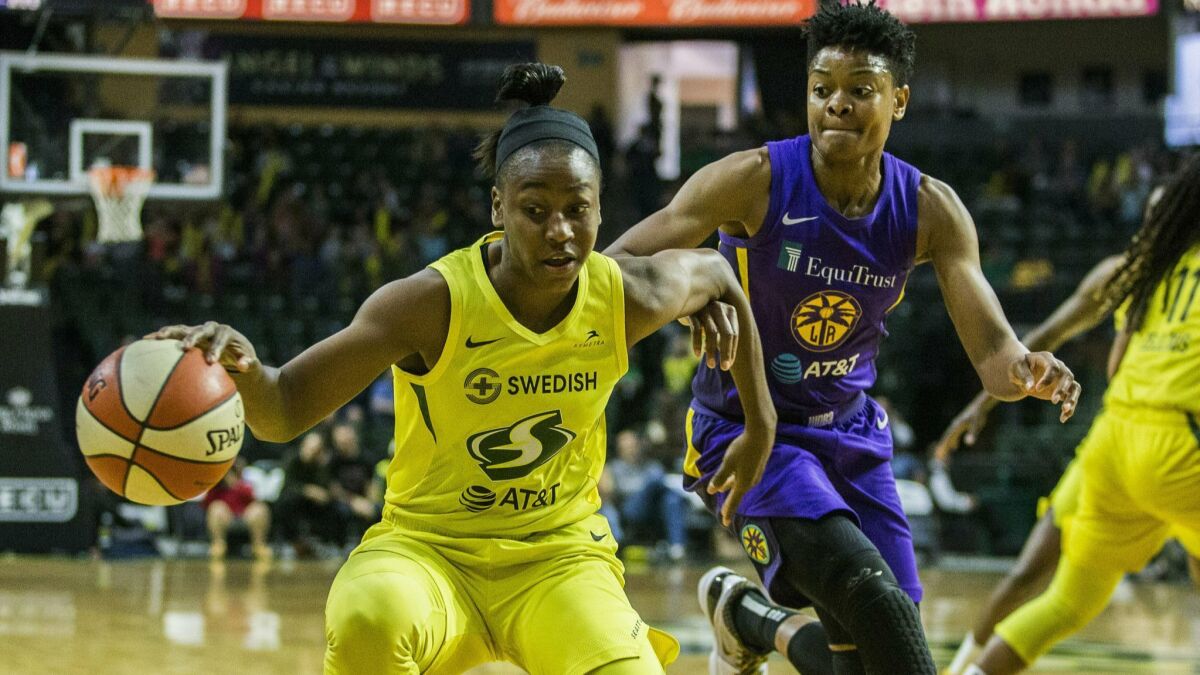 The Storm's Jewell Loyd tries to get around the Los Angeles Sparks' Alana Beard during Seattle's 84-62 victory June 21 in Everett, Wash. Loyd made a career-high five three-pointers and scored 23 points.