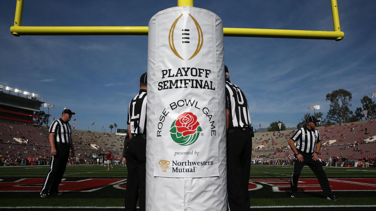 Referees prepare before a College Football Playoff semifinal game at the Rose Bowl.