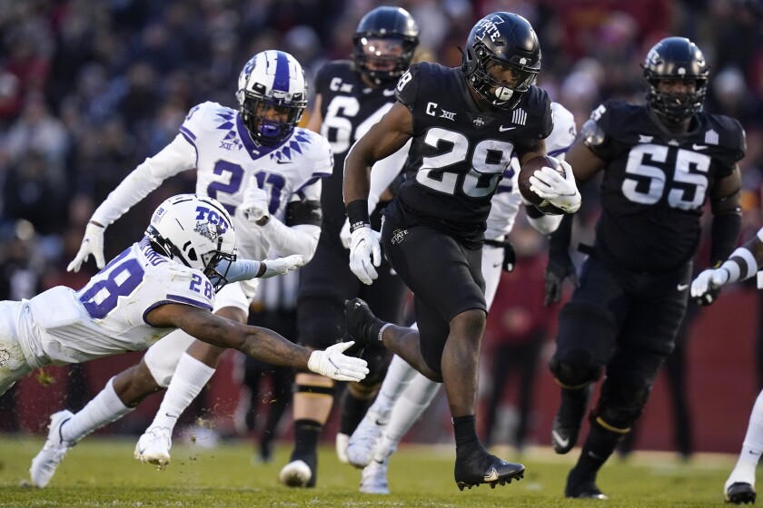 Iowa State running back Breece Hall runs from TCU safety Nook Bradford, left, during a 39-yard touchdown run in the first half an NCAA college football game, Friday, Nov. 26, 2021, in Ames, Iowa. (AP Photo/Charlie Neibergall)